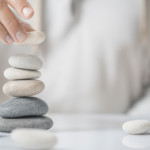 carefully stacking rocks upon solid foundation