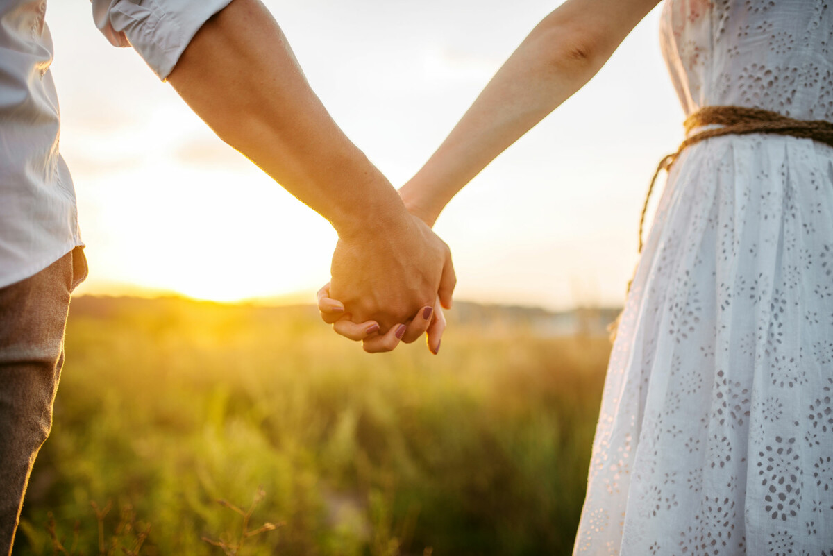 Happy young couple holding hands