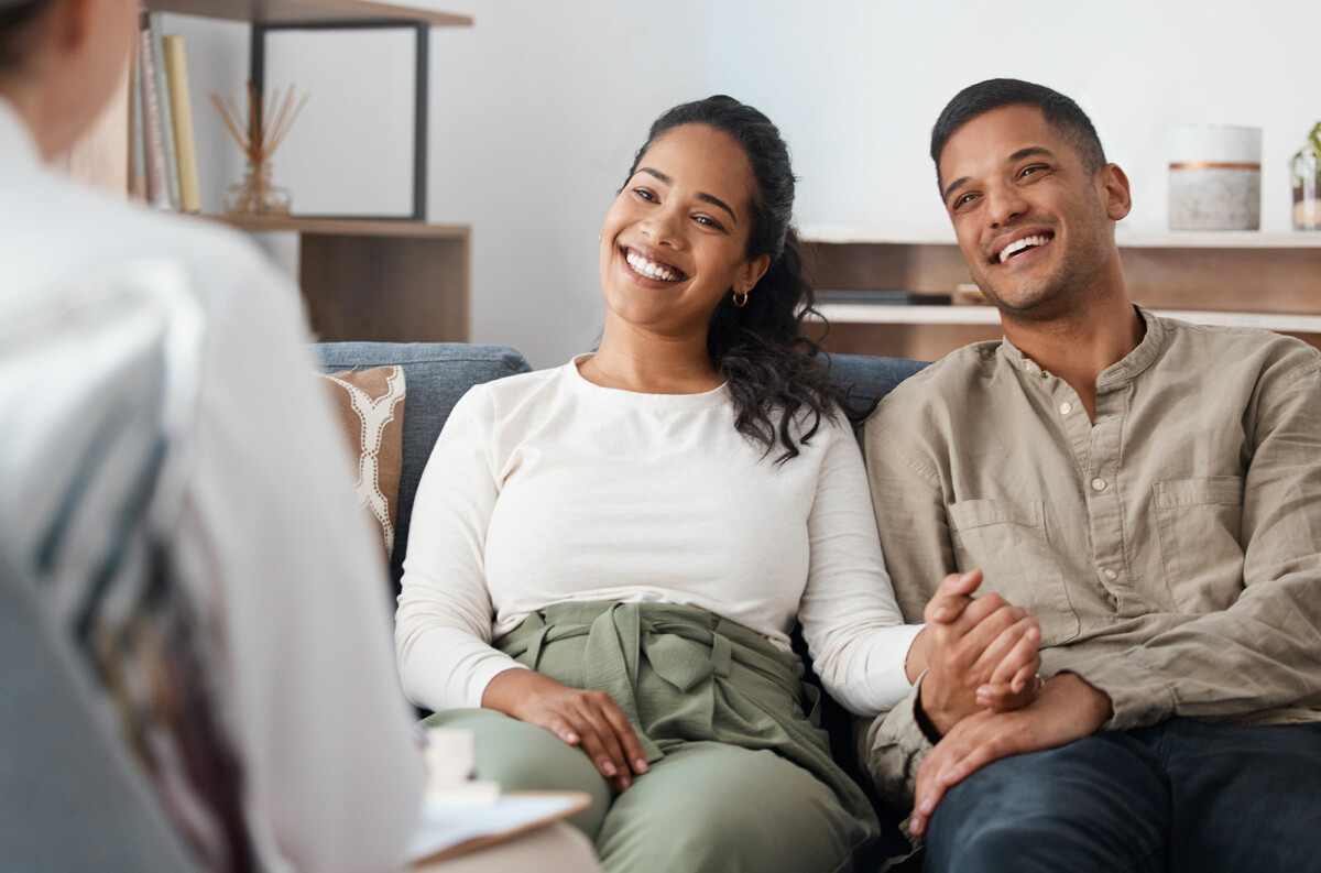 Young couple holding hands during premarital counseling session