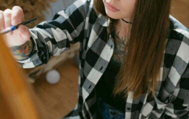 A teen holding and brush and painting