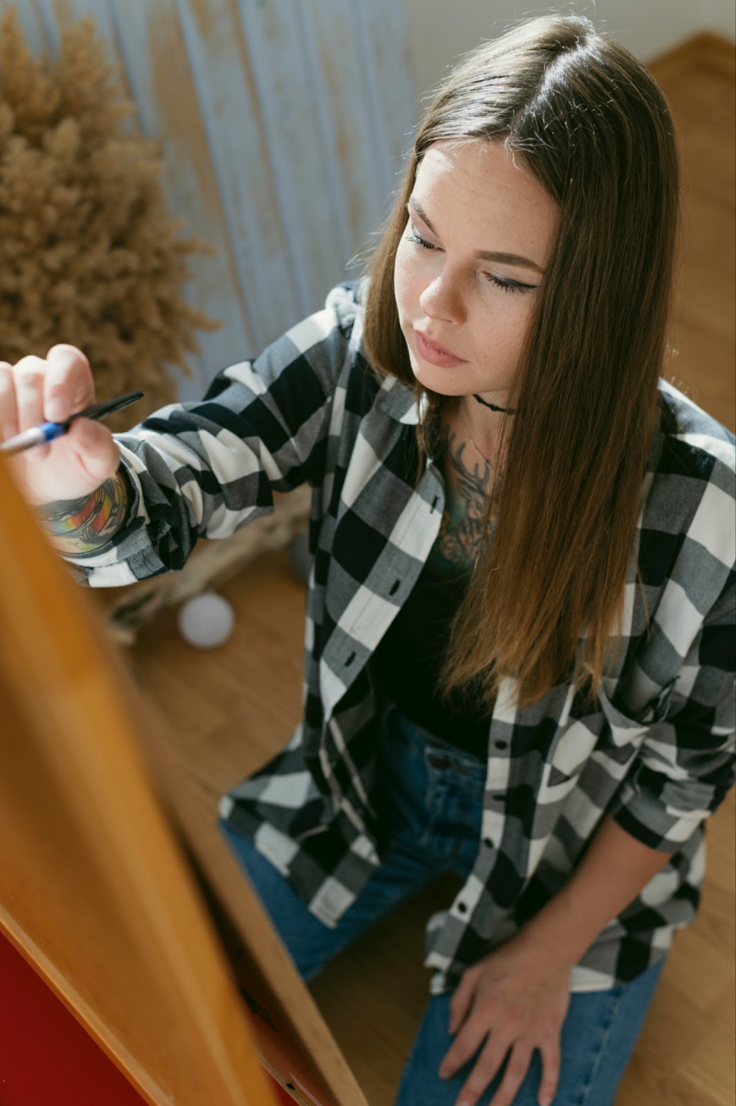A teen holding and brush and painting