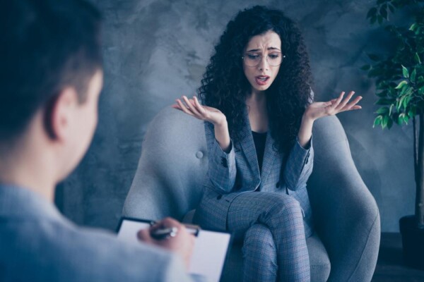 Anxiety counseling Southwest Orlando women getting help at Total Life Counseling Anxious mother consumed by worry holds baby while staring blindly into the distance. Supportive husband looks upon his wife with concern.
