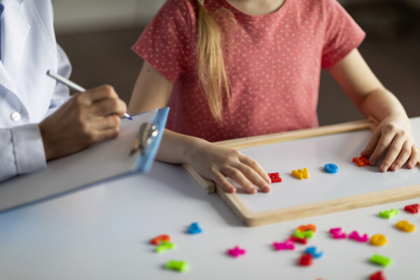 Female Play therapist helping a little girl with Autism at Total Life Counseling Center Clermont