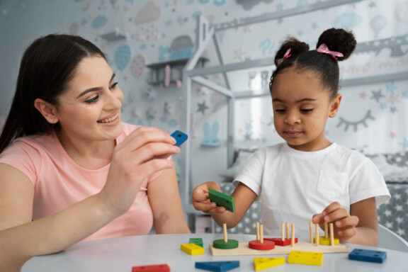 Female Play therapist helping a little girl at Total Life Counseling Center Clermont