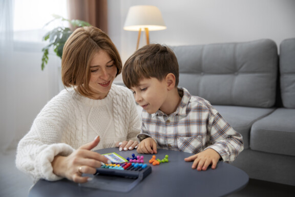 Lake Mary Play therapist helping a boy with Autism at Total Life Counseling Center