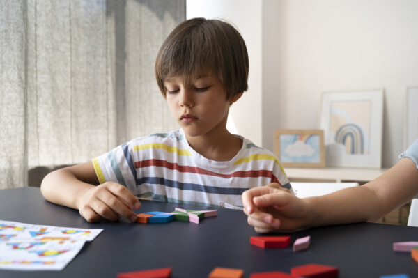 Play therapist helping a little boy with Autism at Total Life Counseling Center Clermont