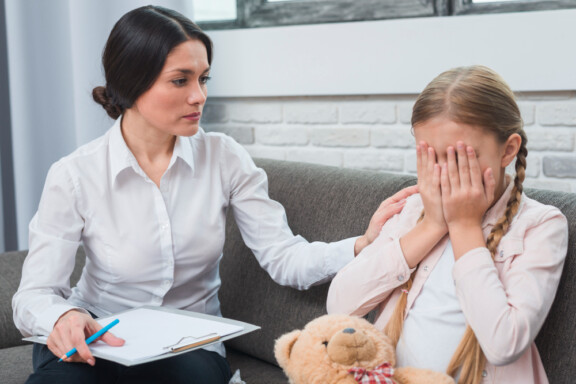 Winter Park Play therapist helping a crying girl with Total Life Counseling Center