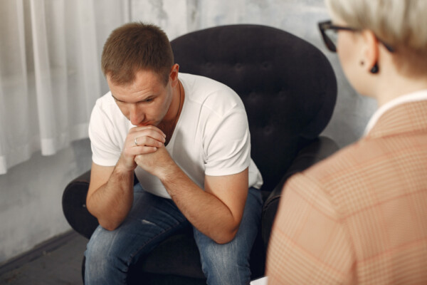 A patient discussing his depression issue with the counselor