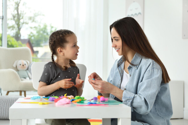 A therapist and a girl in a play therapy session 2 A therapist and a girl in a play therapy session