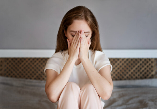 Front view anxious woman sitting in bed