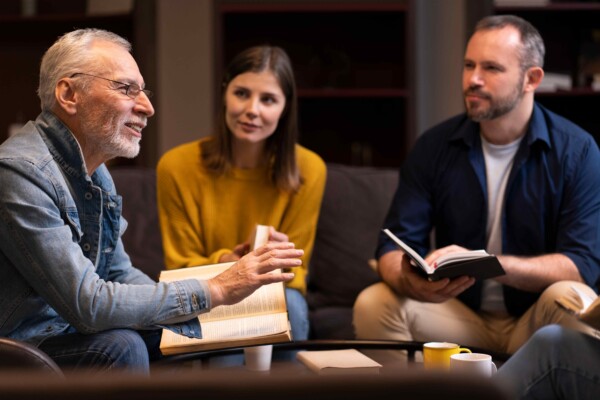 A therapist explaining something to his clients A therapist explaining something to his clients