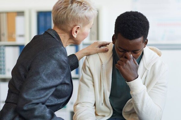 Therapist comforting a client Therapist comforting a client