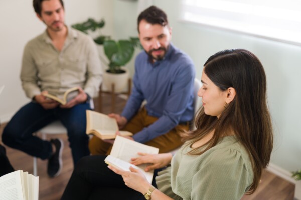 Three people reading the bible Three people reading the bible