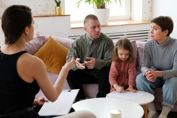 Parents and kid in a therapy session