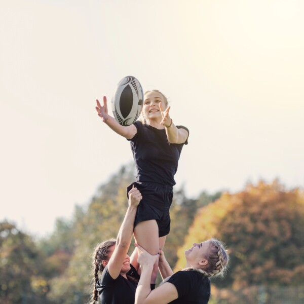 Girl cataching the ball with the help of her teammates Girl cataching the ball with the help of her teammates