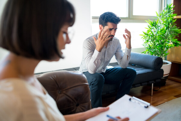 Worried patient explaining his problem to the therapist