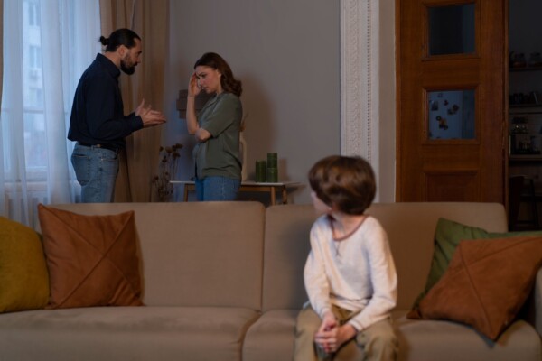 Young child watching parents in a heated argument, feeling isolated