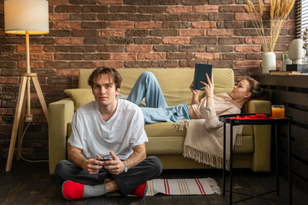Teenager engaged in playing video game.
