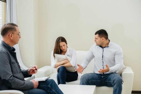 A married couple with a relationship counselor. A married couple with a relationship counselor.