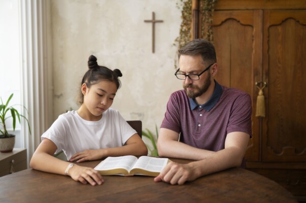 Psychologist teaching bible to a child Psychologist teaching bible to a child