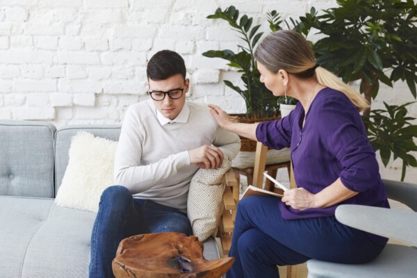 A female therapist consoling her patient A female therapist consoling her patient