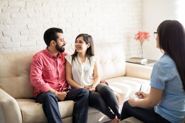A couple sitting at a counselor's office