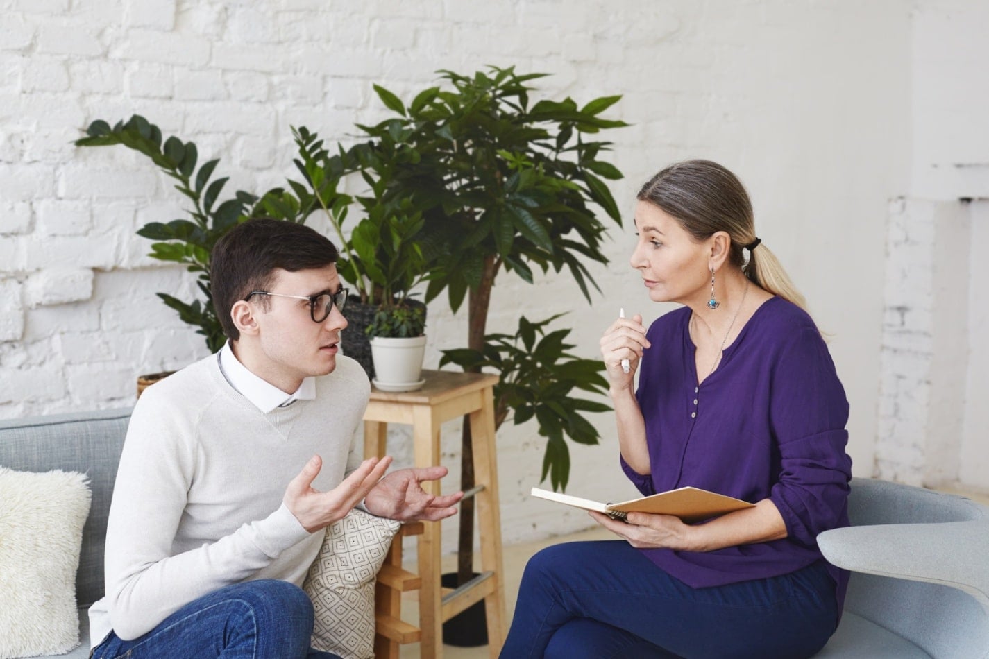 Adult speaking with a mental health professional during a counseling session, representing ADHD assessment, diagnosis, and support for individuals exploring how ADHD may be influenced by genetics and family history.
