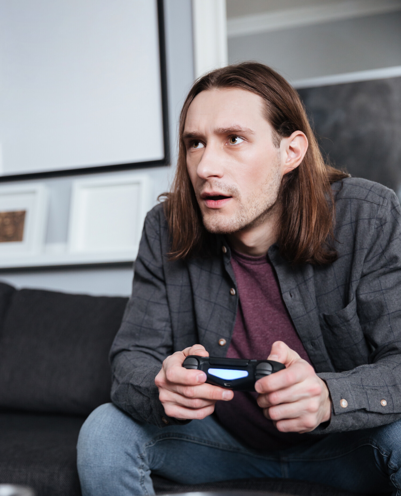 Teenager engaged in playing video game.