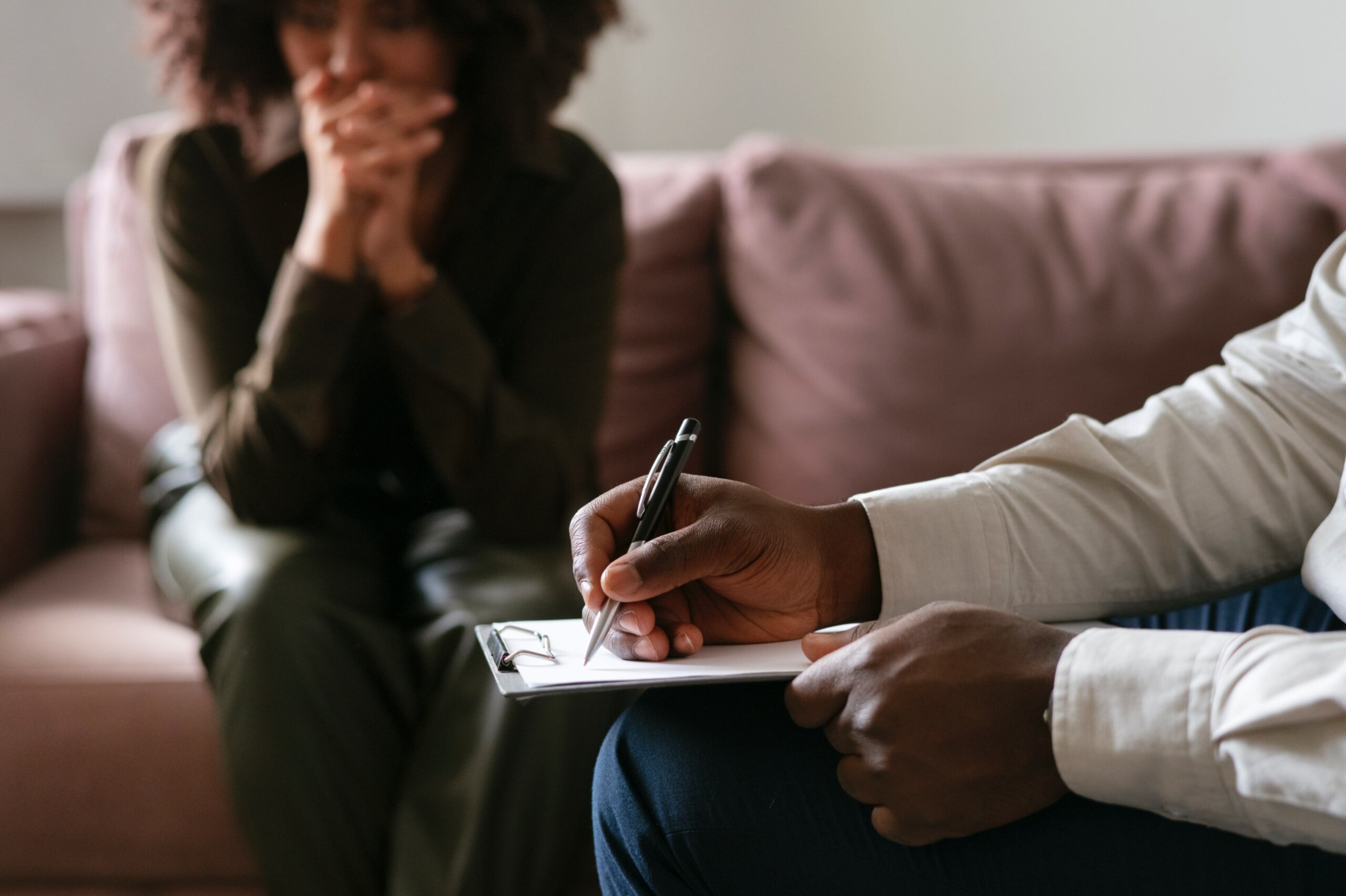 Therapist taking notes during a therapy session