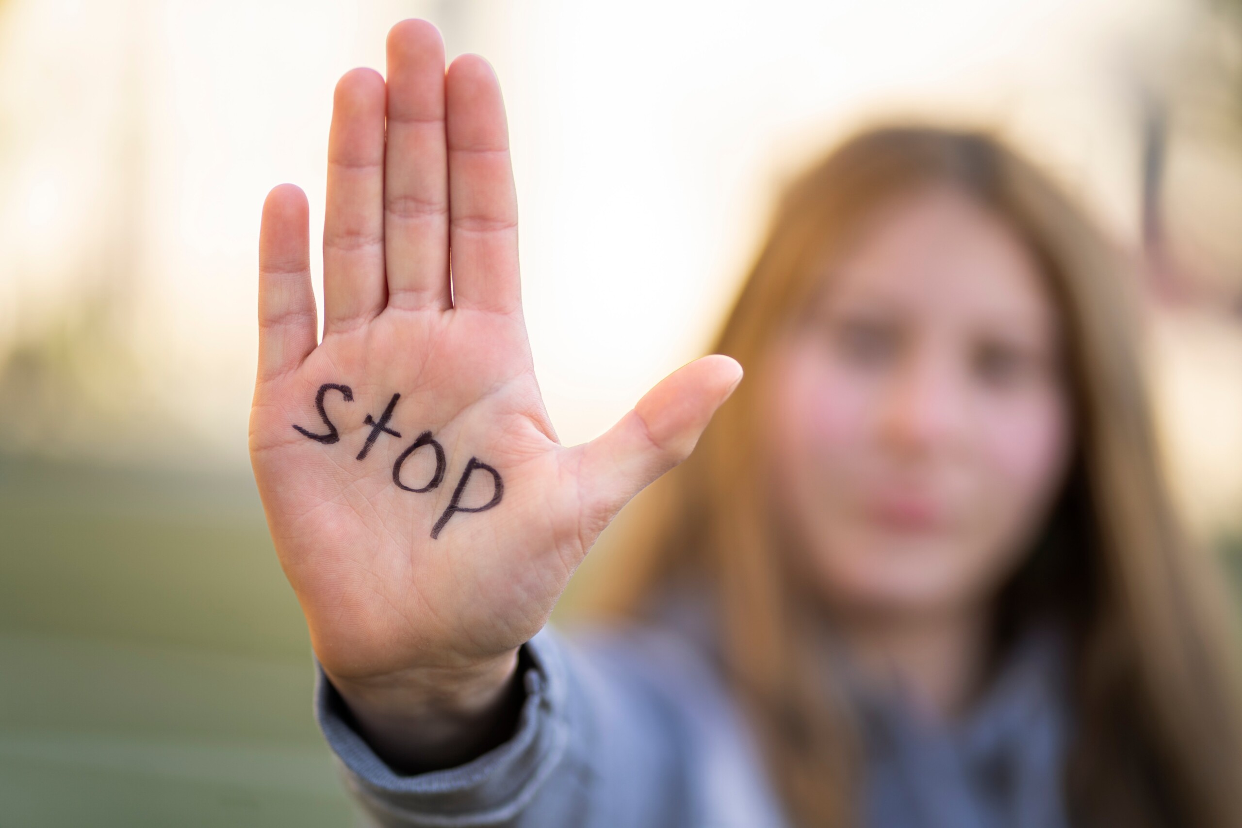 A woman with stop written on her palm
