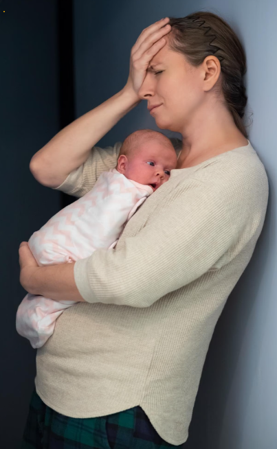 Depressed new mom sitting on the floor with her baby Depressed new mom sitting on the floor with her baby