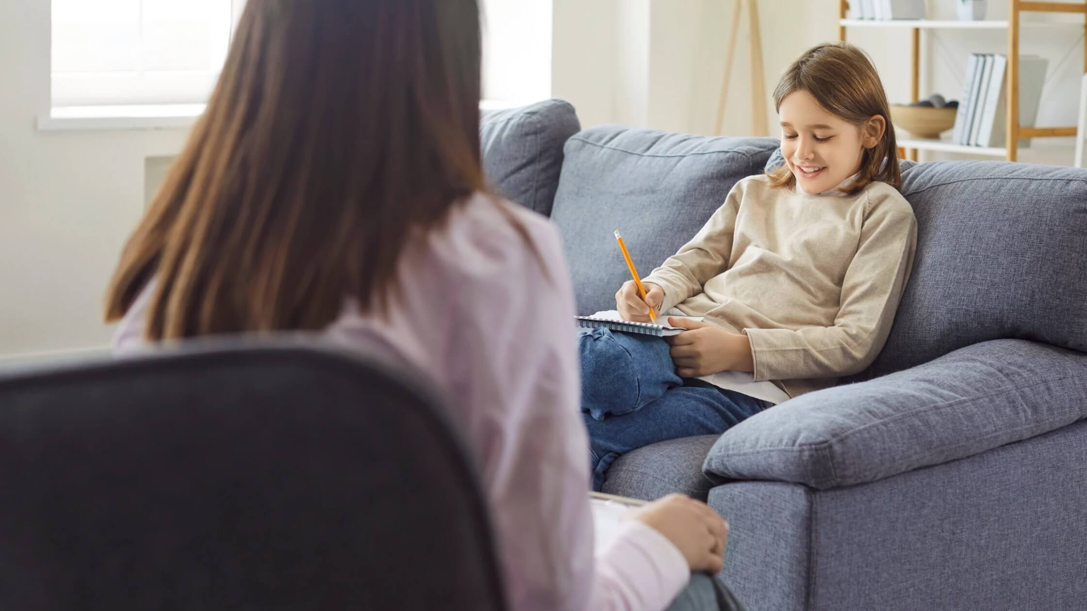 Child participating in a psychological assessment session with a psychologist Child participating in a psychological assessment session with a psychologist