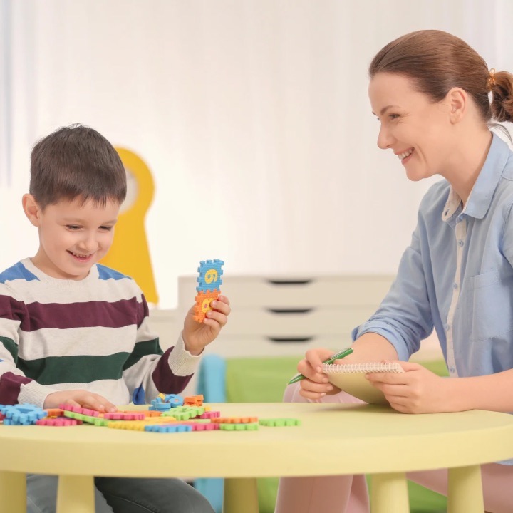 Child engaging in play therapy with psychologist