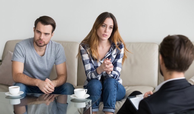 Couple looking upset during a counseling session with therapist. Couple looking upset during a counseling session with therapist.