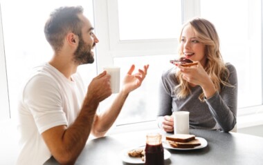 A smiling couple sitting at a breakfast table, enjoying coffee and toast while having a relaxed conversation near a bright window. - Total Life Counseling for Children, Teens, Adolescents and Adults in Orlando Winter Park Clermont Lake Mary and Central Florida A smiling couple sitting at a breakfast table, enjoying coffee and toast while having a relaxed conversation near a bright window.