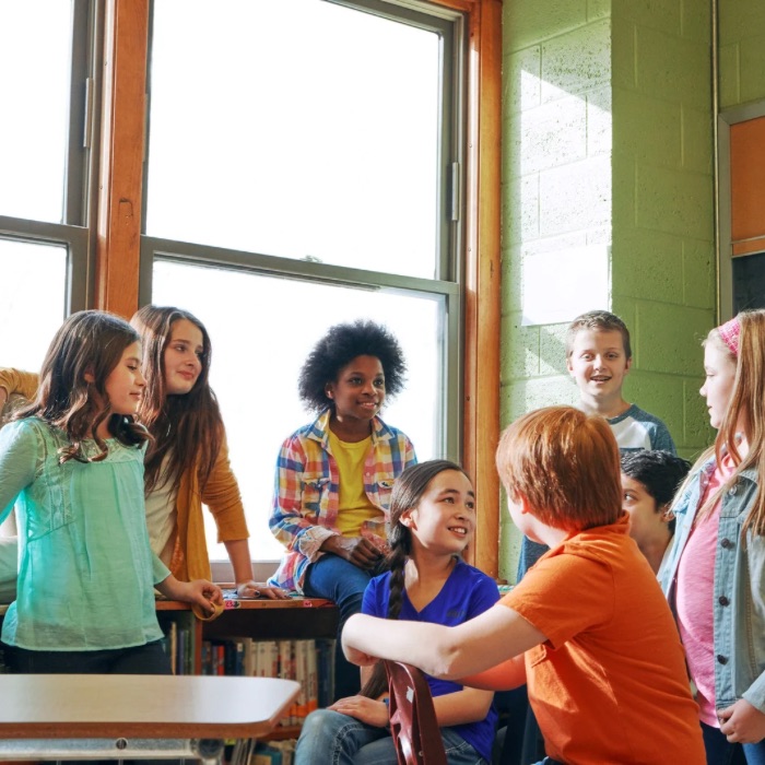 Smiling children playing tug of war in a social skills group