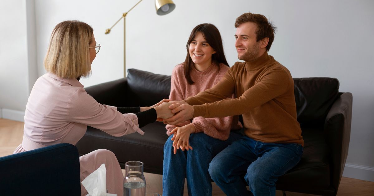 Couple shaking hands with the counselor after a counseling session