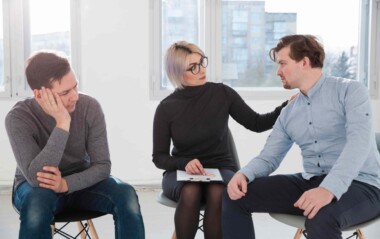 A therapist and two clients in a session