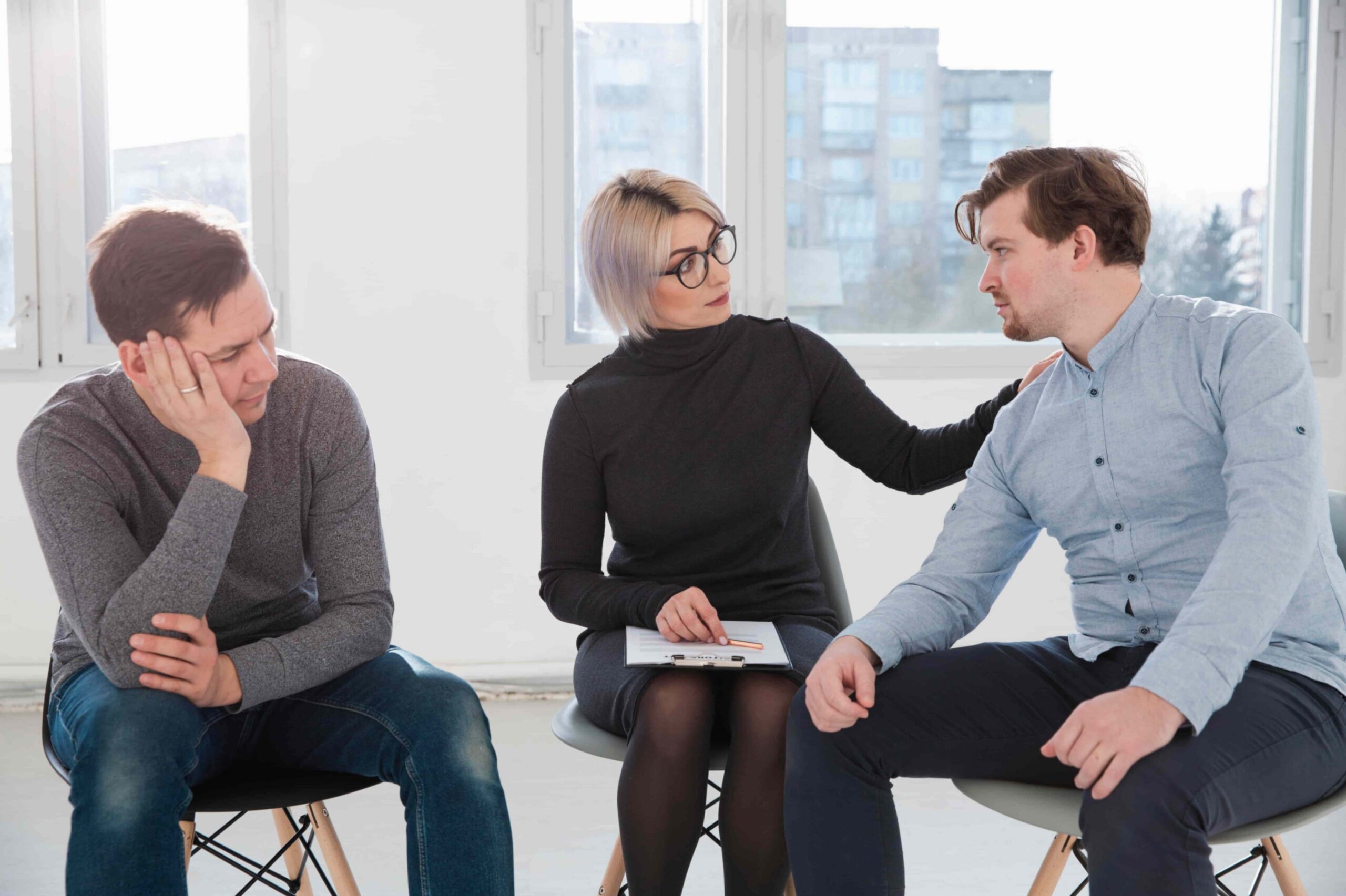 A therapist and two clients in a session
