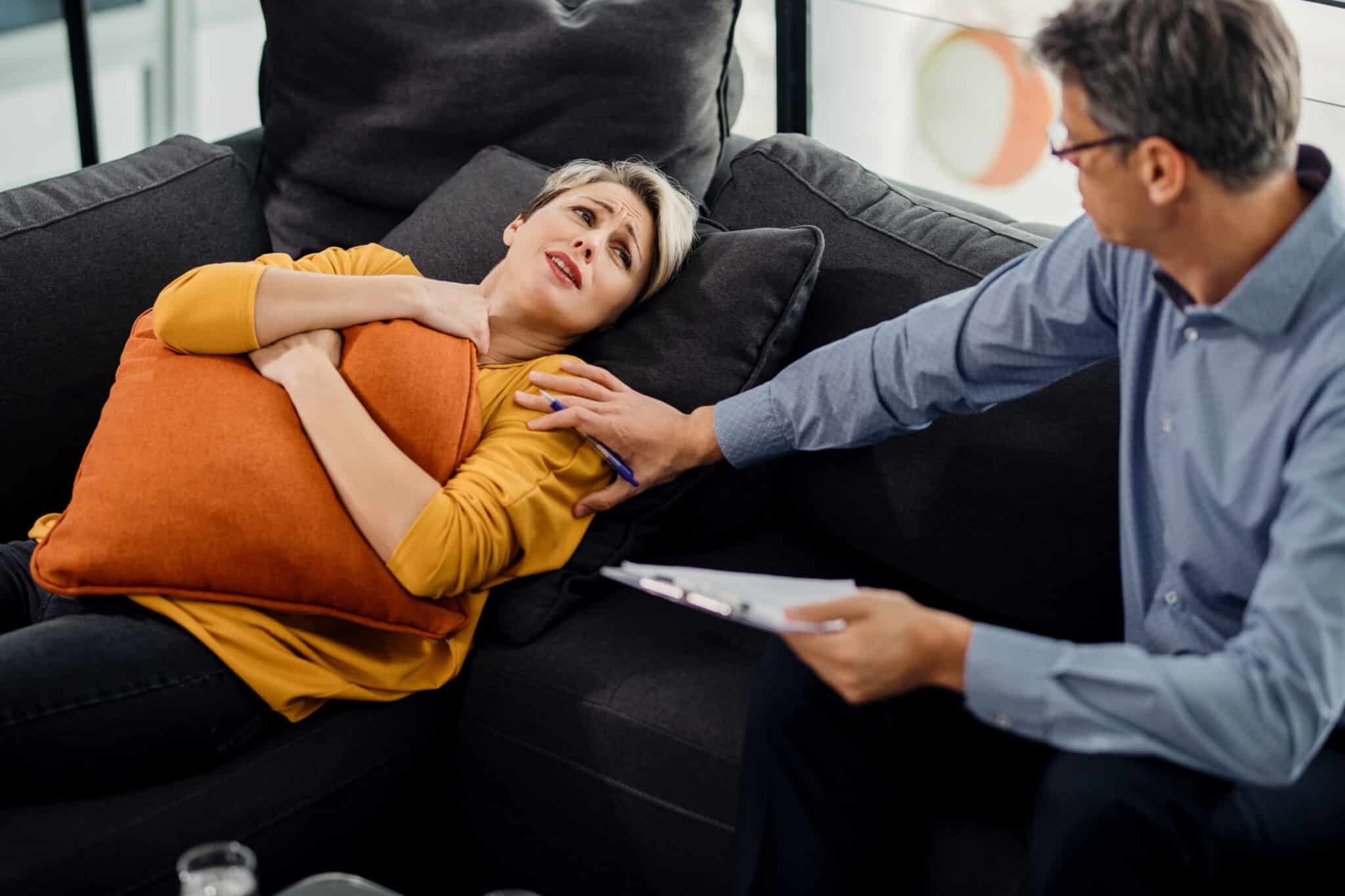 Woman experiencing distress during a therapy session. - Total Life Counseling for Children, Teens, Adolescents and Adults in Orlando Winter Park Clermont Lake Mary and Central Florida Woman experiencing distress during a therapy session.